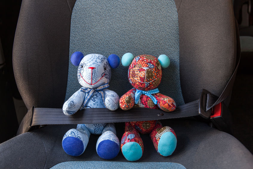 stuffed animals sitting in car seat