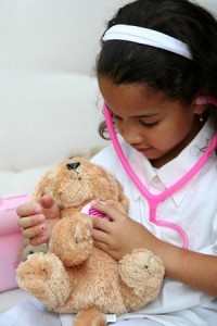 girl playing with stuffed animal