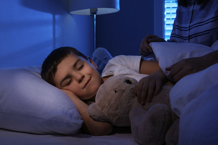 Little boy sleeping with teddy bear