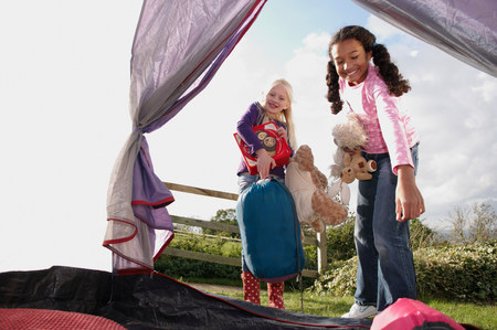 Girls playing with stuffed animals outside
