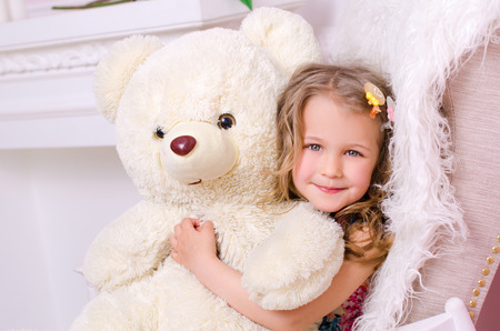 Girl Hugging white Teddy Bear