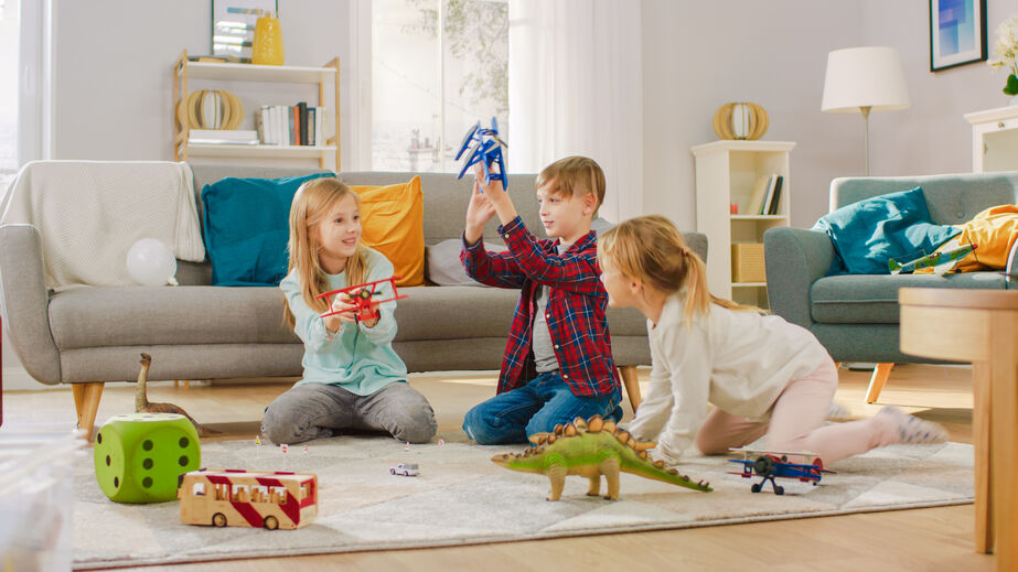 children playing in living room with toys