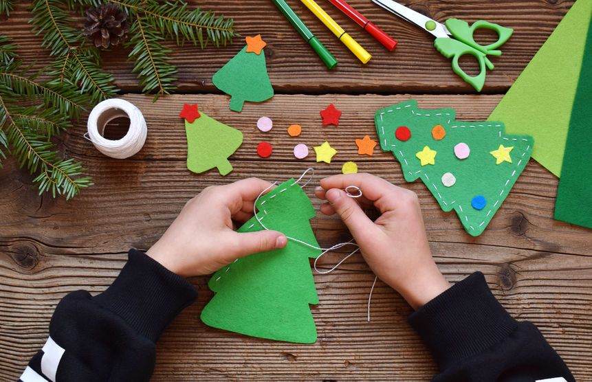 child making handcrafted christmas trees
