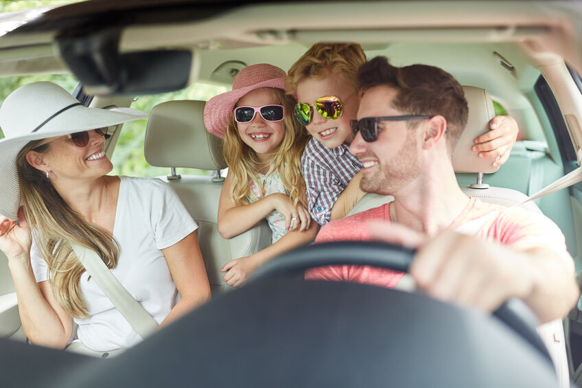 family driving in car for day trip