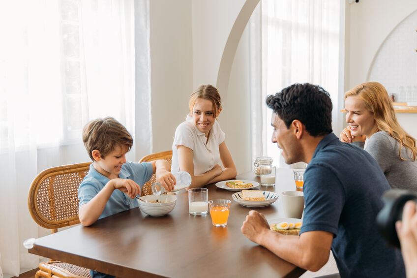 parents talking to toddler at dinner table