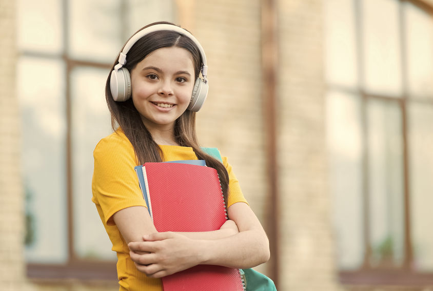 preteen girl holding school books